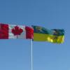 Canadian flag and Saskatchewan Provincial flag blowing in the wind at the Alberta-Saskatchewan border.VRIDETV.com is VIRTUAL RIDING TELEVISION